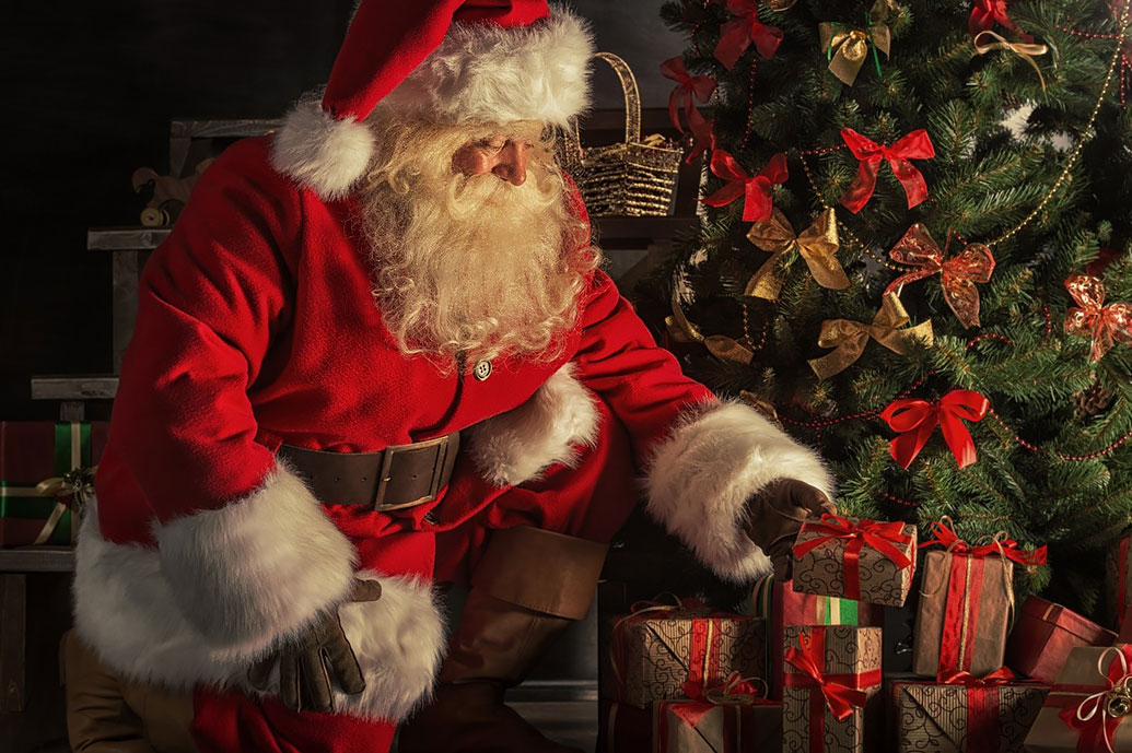 Santa Claus in red coat brings gifts